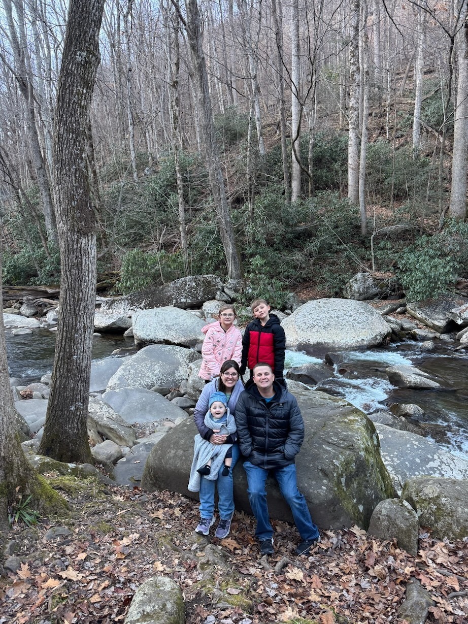 Lauren Foret and family in the woods near a creek
